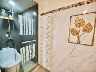 Modern bathroom with enclosed shower and decorative wall art