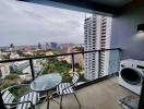 High-rise apartment balcony with city view and outdoor furniture