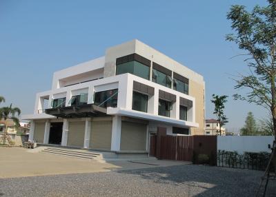 Modern two-story building with balconies and large windows