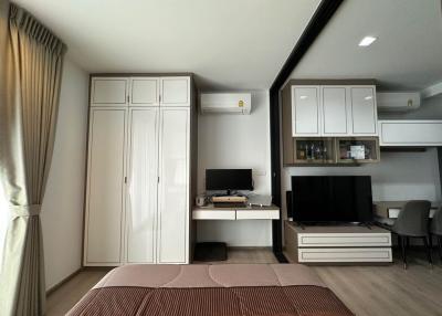 Modern bedroom interior with television and wardrobe