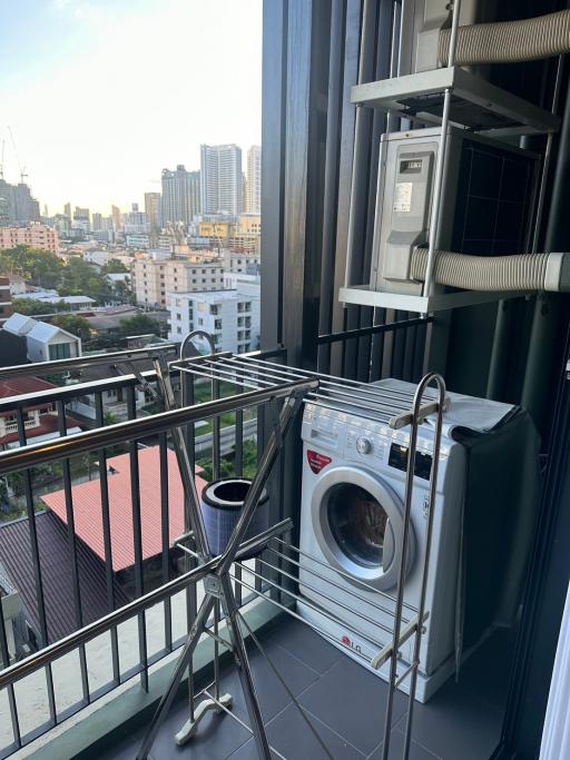 Urban apartment balcony with washing machine and air conditioning unit