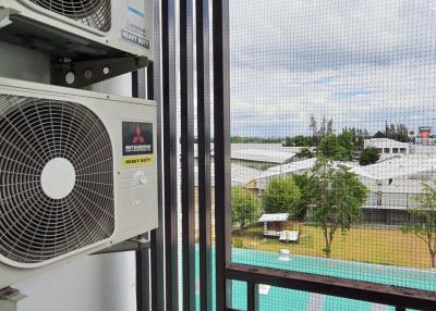 Apartment balcony with air conditioning units and view of outdoor pool
