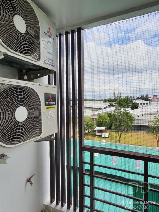 Apartment balcony with air conditioning units and view of outdoor pool