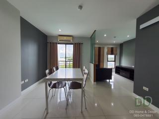 Modern dining area with open floor plan, adjacent to living room