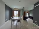 Modern dining area with open floor plan, adjacent to living room