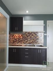 Modern kitchen with tile backsplash and dark cabinets