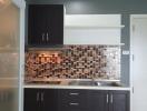 Modern kitchen with tile backsplash and dark cabinets