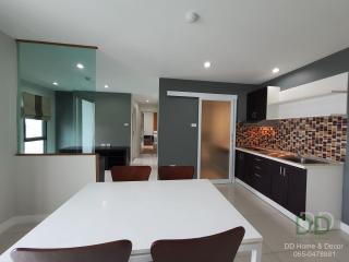 Modern kitchen with white dining table and adjacent living area
