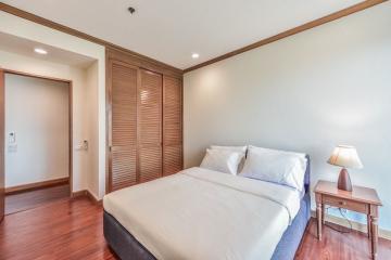 Cozy bedroom with wooden flooring and modern furnishings