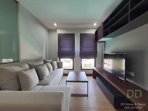 Modern spacious living room with large sofa and flat-screen TV