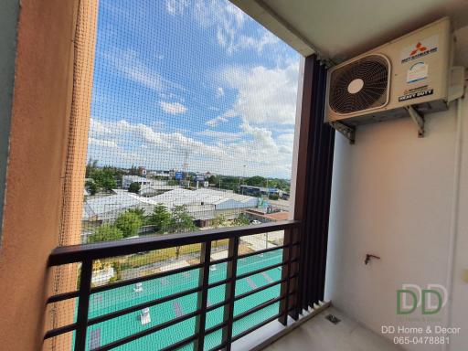 Balcony with a view of the city and an air conditioning unit