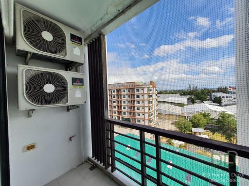 Apartment balcony with air conditioning units and a view of the surrounding area