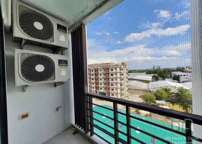 Compact balcony with air conditioning units and a city view