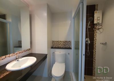 Modern bathroom interior with white ceramic fixtures and decorative mosaic tiles