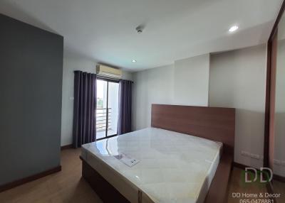 Spacious bedroom with modern design, king-sized bed, and ample natural light