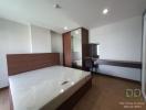 Spacious furnished bedroom with large bed and natural light