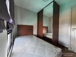 Compact bedroom with a large bed, mirrored wardrobe, and neutral color scheme