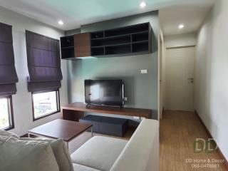 Modern living room with mounted television and comfortable seating