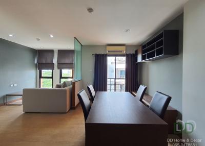 Spacious and well-lit living room with dining area and balcony access in a modern apartment