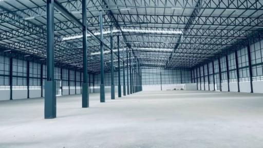 Spacious empty industrial warehouse with metal structure