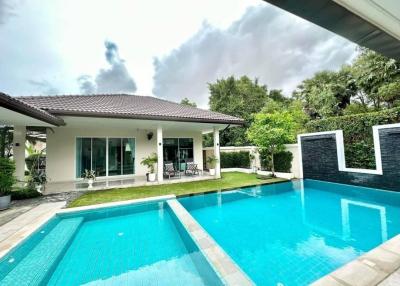 Spacious backyard with swimming pool and modern house