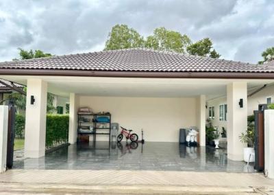 Spacious carport with tiled flooring and roof in a residential building