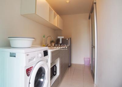 Modern home laundry room with washer and cabinets