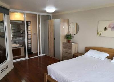 Cozy bedroom with en suite bathroom and wooden flooring