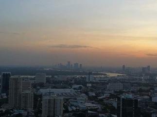 Scenic sunset cityscape with buildings and water views