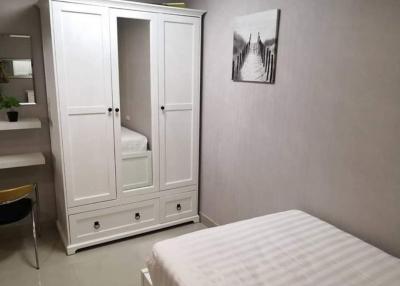 Cozy bedroom with white wardrobe and minimalistic decor