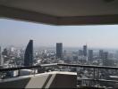 Panoramic city view from high-rise apartment balcony