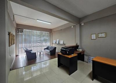 Spacious home office with lounge area and ample natural light