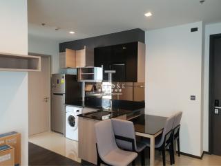 Modern kitchen with stainless steel appliances and a small dining area