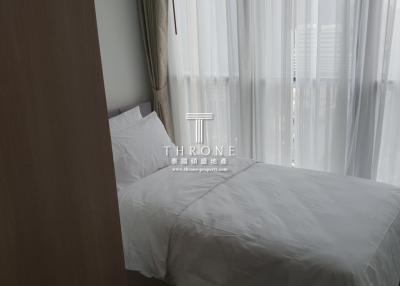 Minimalistic bedroom with white bedding and sheer curtains