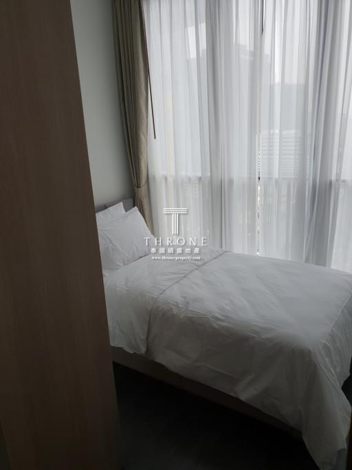 Minimalistic bedroom with white bedding and sheer curtains