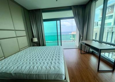 Modern bedroom with ocean view and balcony access