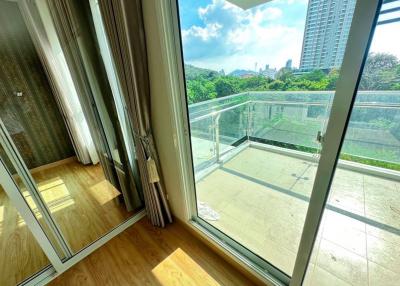 Bright sunny balcony with city view and hardwood flooring