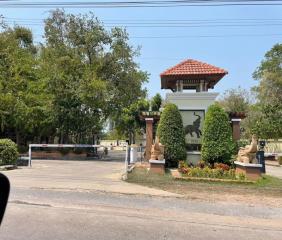 Entrance of a residential estate with security booth and gate