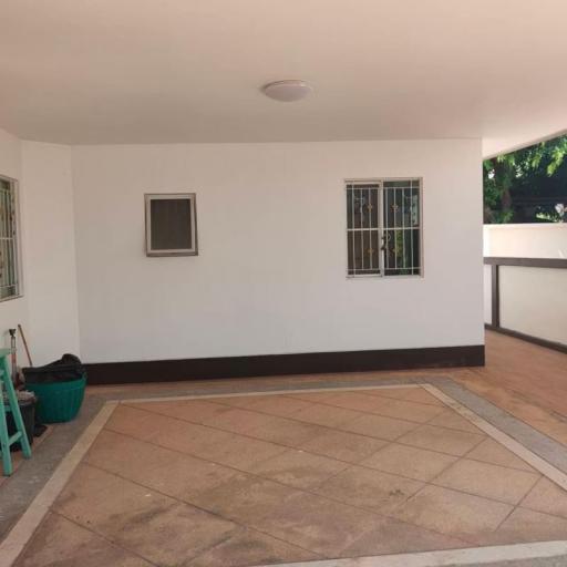 Spacious patio area with tiled flooring and a secure window