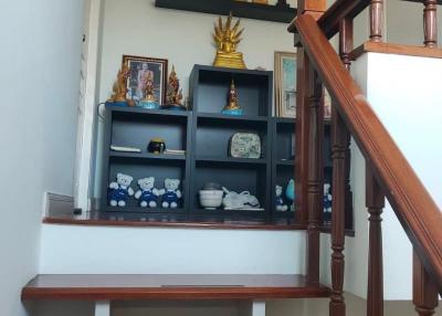 Wooden staircase with decorative shelving unit