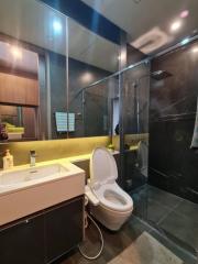 Modern bathroom with glass shower and large mirror