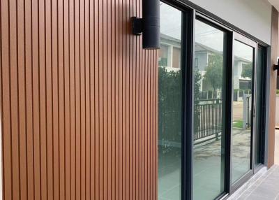 Modern building exterior with vertical wooden slats and sliding glass doors