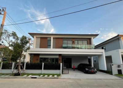 Modern two-story house with balcony and garage