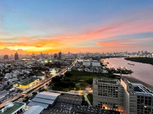 Panoramic cityscape at sunset with vibrant sky from high vantage point