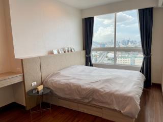 Modern bedroom with a view of the city skyline