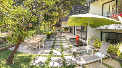 Spacious outdoor patio area with comfortable seating and lush greenery