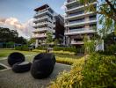 Modern apartment buildings with outdoor relaxation area and green landscaping
