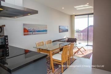 Modern dining room with open space concept, large windows, and art on the wall