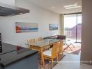 Modern dining room with open space concept, large windows, and art on the wall