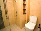 Modern bathroom with walk-in shower and beige tiles